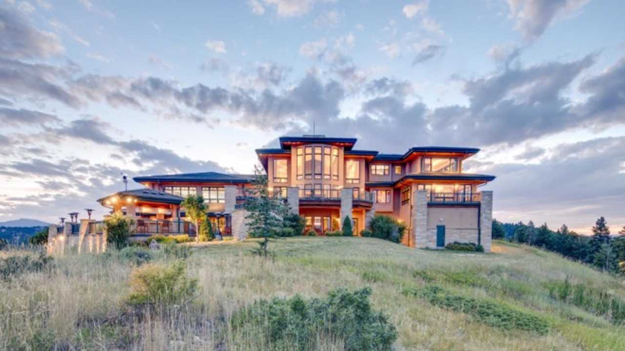 Landscape photo of the front of the Richard Berry Estate. At dusk with a partly cloudy sky in the background.