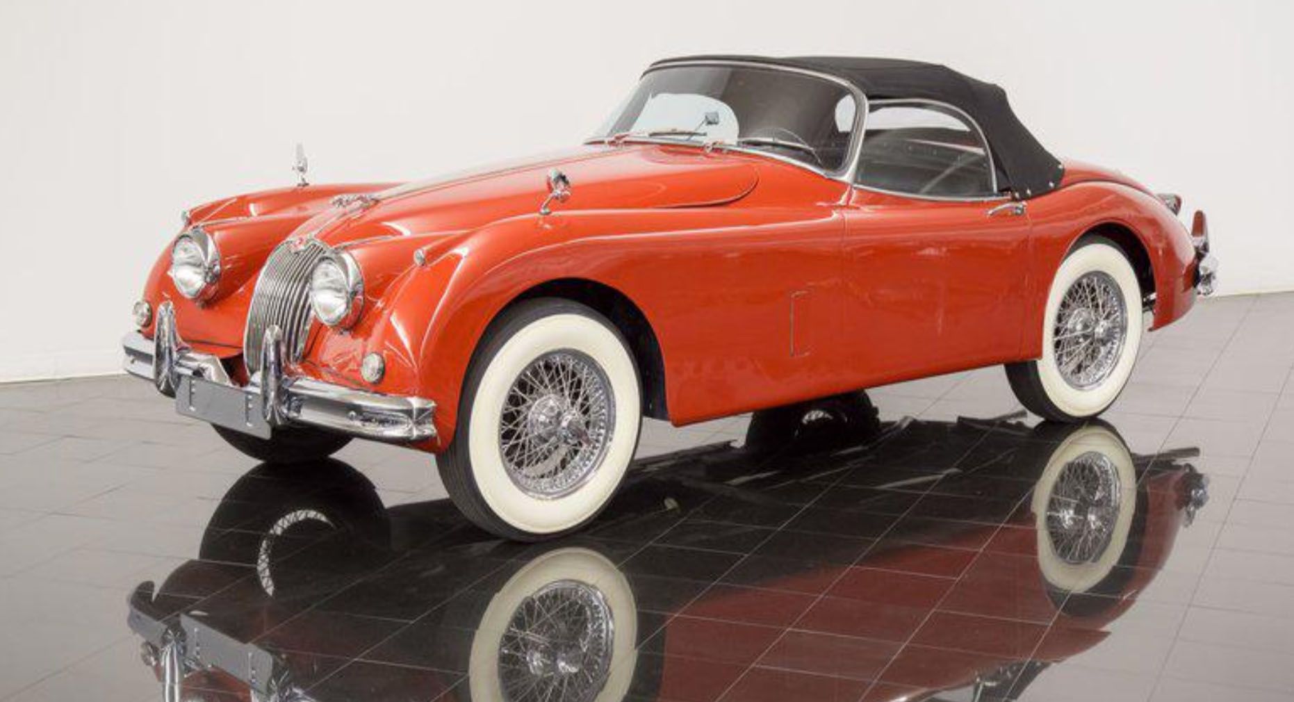 <img src="1959-jaguar-xk150.jpg" alt="A pristine 1959 Jaguar XK150 SE Roadster in Carmen Red">