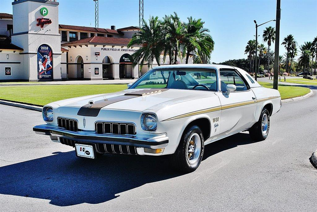 <img src="1973-oldsmobile-front-three-quarters.png" alt="The front of a 1973 Oldsmobile Hurst W-30 Cutlass up for bids">