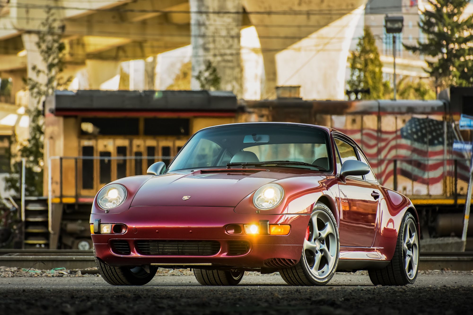 <img src="1997-porsche-911-carrera-4s.jpg" alt="The front of a 1997 Porsche 911 Carrera 4S in Arena Red Metallic">