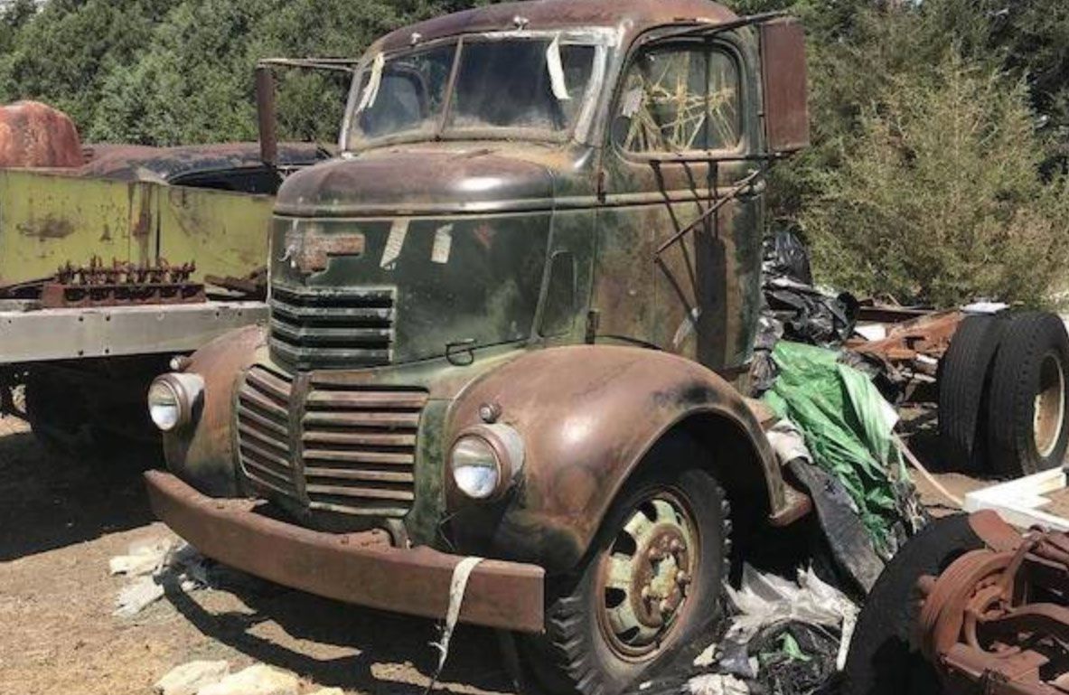 <img src="scrapyard10.jpg" alt="An old rusty truck sits in a scrapyard">