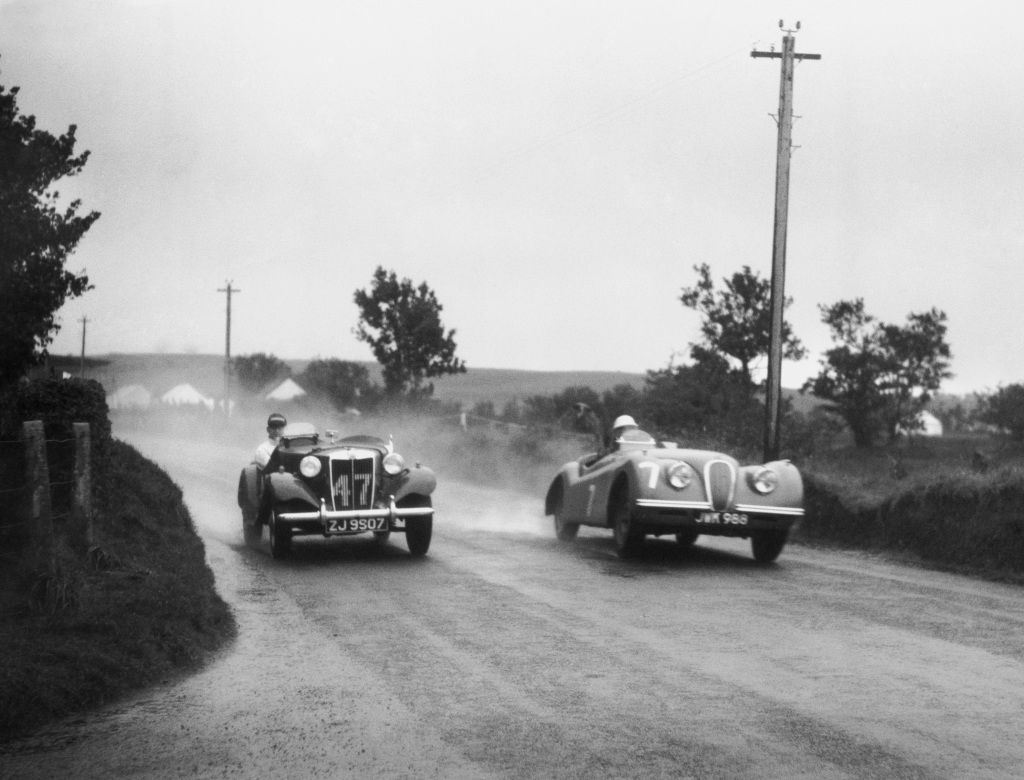 <img src="stirling-jaguar.jpg" alt="Stirling Moss behind the wheel of a Jaguar XK120 at Dundrod in Northern Ireland">