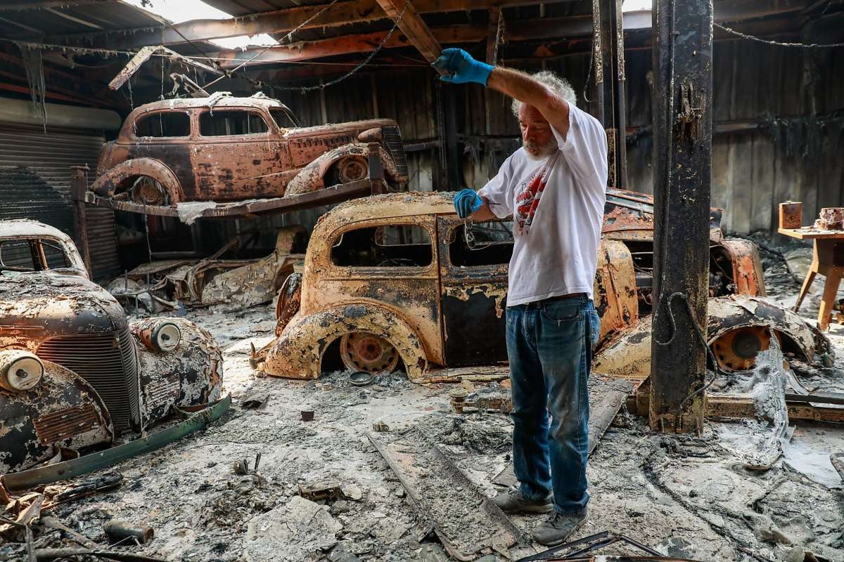 <img src="ken-albers.jpg" alt="Ken Albers stands among his torched collection of restored classic Chevrolets">