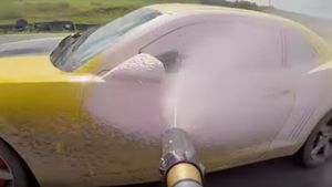Guys Attempts To Wash A Moving Camaro